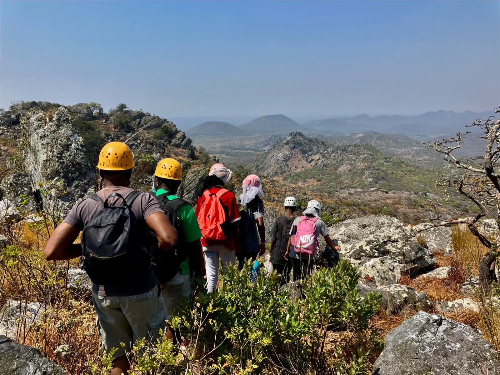 A hiking group travelling through rocky mountain terrain